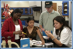 Miami Dade Students looking at a text book